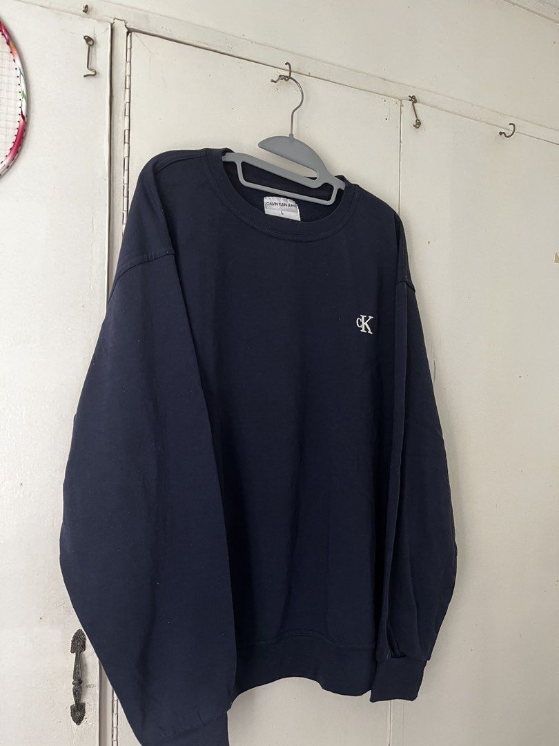 Calvin Klein Jeans Sweatshirt (Category: Hoodies) located in Manila. Submitted by jojo_declutter (Listing ID 1452772247, Image 1). Description: - Navy Blue Calvin Klein Sweatshirt - Size L on tag (oversized fit) - Dimes: 23x28 - Color rate: 9.5/10 - no issues good as new gcash payment lalamove or j&t shipping qc loc dm for more info!.