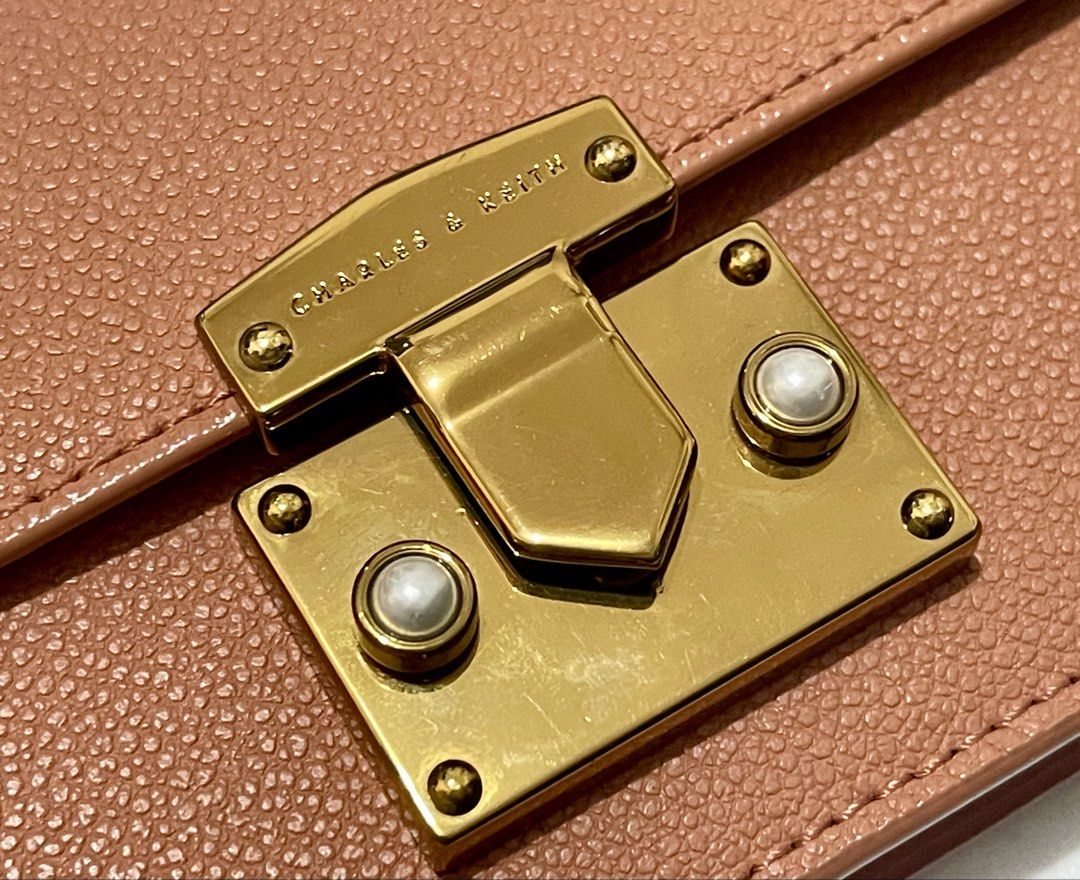 Charles & Keit Wallet on Chain (Slightly Negotiable) (Category: Wallets & Card holders) located in Imus. Submitted by cheratedfinds (Listing ID 1452755665, Image 2). Description: Charles & Keith Pearl Accent Push-Lock Chain Wallet Crossbody Bag - Dusty Rose Pink A sleek and functional piece in textured pebbled faux leather with elegant gold-tone hardware and pearl push-lock detailing. Features a detachable gold chain strap so you can wear it as a