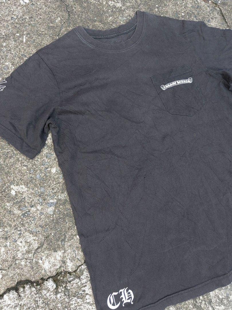 Chrome Hearts Pocket T-Shirt (Category: Tshirts & Polo Shirts ) located in Las Pinas. Submitted by huslerz (Listing ID 1452768999, Image 3). Description: - Black Chrome Hearts T-shirt - Iconic cross graphic on the back - Pocket logo detail - Small 'CH' detail at the hem - Minor flaw: tiny hole on the front (visible in the last photo) - Ideal for everyday casual wear 20x27.5.