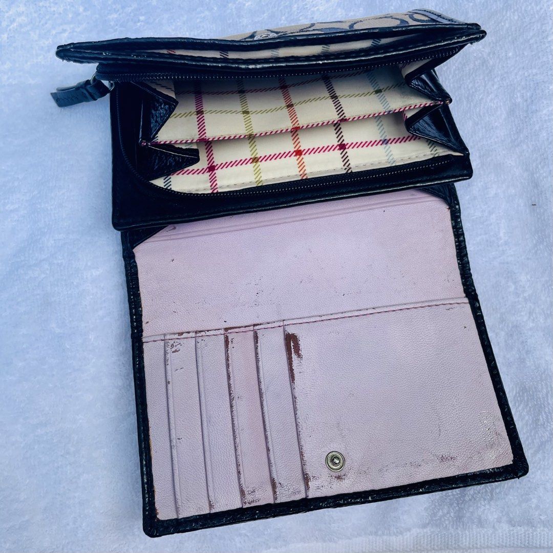Coach Monogram Trifold Wallet (Category: Luxury Bags & Wallets) located in Caloocan City. Submitted by pandadada01 (Listing ID 1451864241, Image 2). Description: - Authentic Coach trifold wallet - Classic monogram pattern with leather accents - Embossed Coach logo and 'Est. 1941' on front - Secure zipper closure with pull tab - Plenty of space for cards and cash.