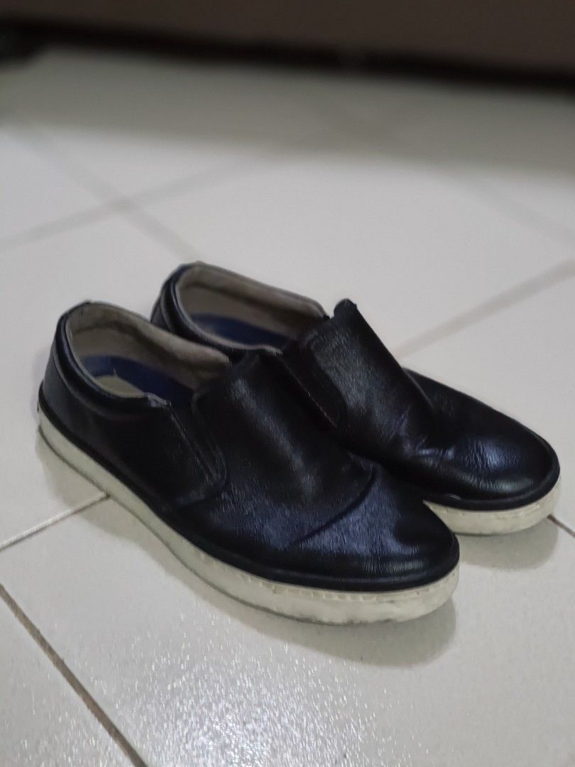Cole Haan Slip-On Leather Sneakers (Category: Casual Shoes) located in Makati City. Submitted by tabsilog (Listing ID 1452813808, Image 1). Description: - Brand: Cole Haan Falmouth Grand OS - Type: Slip-on sneakers - Material: Black leather - Features: Grand.OS comfort technology - Sole: Cole Haan logo - Best for: Casual wear - Condition: Shows some signs of wear on soles and leather, but plenty of life left. price neg.