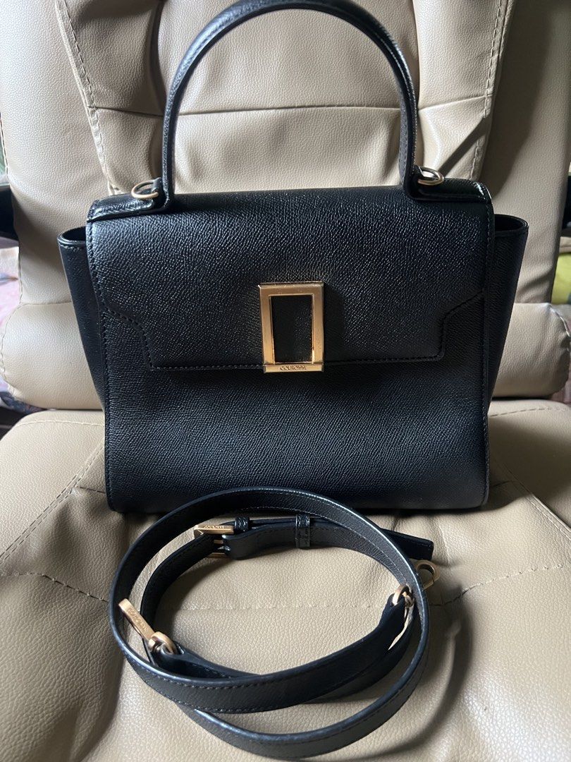 Couronne Black Leather Top Handle Bag with Shoulder Strap (Category: Shoulder Bags) located in Saravia. Submitted by clynlyn (Listing ID 1452766867, Image 1). Description: - Genuine black leather Couronne handbag - Elegant structured design - Secure gold-tone buckle closure - Versatile detachable shoulder strap - Interior zippered pocket for essentials - Classic and clean style, suitable for daily wear or special events.