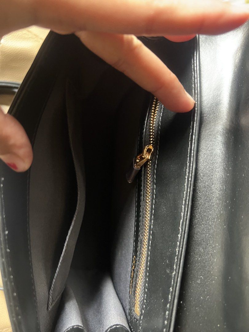 Couronne Black Leather Top Handle Bag with Shoulder Strap (Category: Shoulder Bags) located in Saravia. Submitted by clynlyn (Listing ID 1452767318, Image 2). Description: - Genuine black leather Couronne handbag - Elegant gold clasp closure - Comfortable top handle - Includes a detachable shoulder strap for versatility - Interior zippered pocket for secure storage - Stylish gold hardware details - Timeless and clean design - Ideal for both every