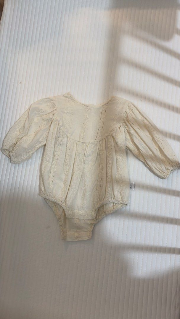 Cream Eyelet Lace Long Sleeve Baby Romper (Category: Babies & Kids Fashion) located in Abucay. Submitted by kmdqs (Listing ID 1452856721, Image 1). Description: - Cream colored baby romper - Delicate eyelet lace details all over - Long puff sleeves with elastic cuffs - Convenient snaps at the bottom for easy diaper changes - Made of soft and breathable 100% cotton - Size 66.