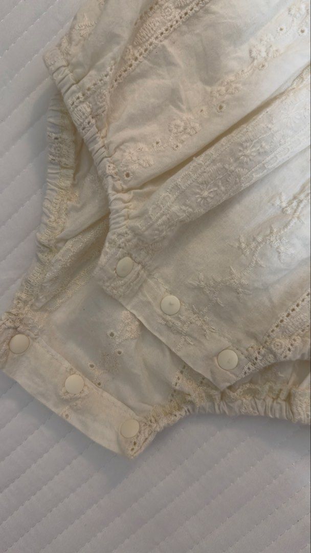 Cream Eyelet Lace Long Sleeve Baby Romper (Category: Babies & Kids Fashion) located in Abucay. Submitted by kmdqs (Listing ID 1452856721, Image 3). Description: - Cream colored baby romper - Delicate eyelet lace details all over - Long puff sleeves with elastic cuffs - Convenient snaps at the bottom for easy diaper changes - Made of soft and breathable 100% cotton - Size 66.