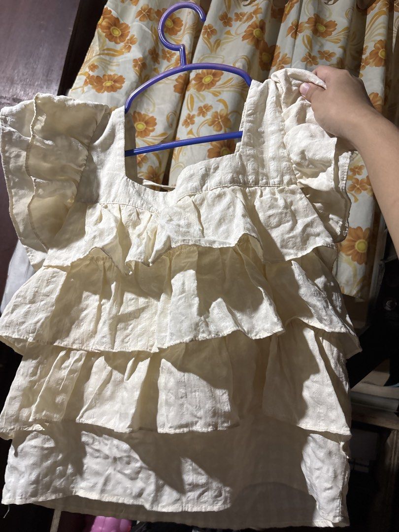 Cream Ruffle Square Neck Puff Sleeve Blouse (Category: Blouses) located in Taguig. Submitted by .akate (Listing ID 1452791901, Image 2). Description: can fit m-l frame Cream colored blouse with a square neckline. Features short puff sleeves and tiered ruffles down the front. Has a tie detail at the neckline. Lightweight fabric, great for warmer weather. Easy to pair with skirts or pants..