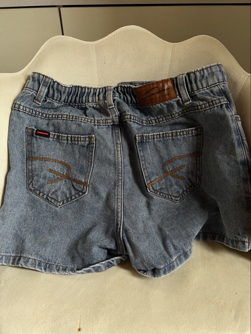 FUBU Denim Skort (Category: Shorts) located in Las Pinas. Submitted by reiclutter (Listing ID 1452727376, Image 2). Description: - FUBU Blue denim skort - Button fly front with elastic back waistband - Distressed details on the sides - Two front pockets and two back pockets.