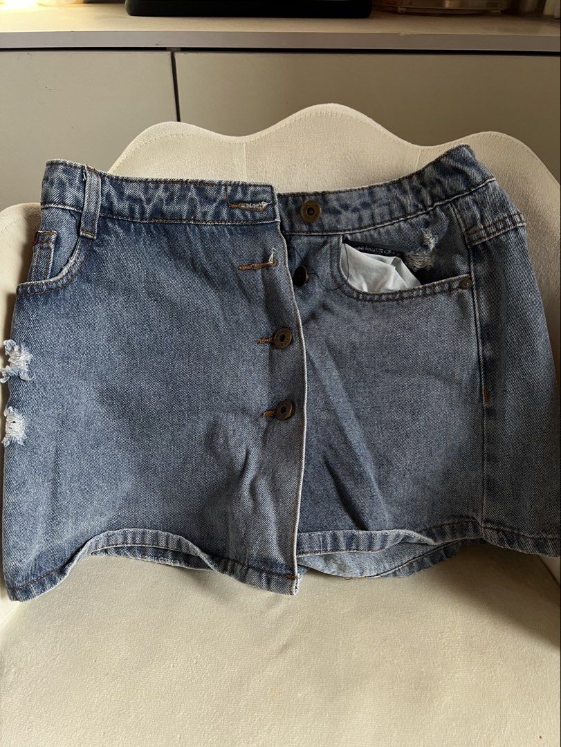 FUBU Denim Skort (Category: Shorts) located in Las Pinas. Submitted by reiclutter (Listing ID 1452727376, Image 1). Description: - FUBU Blue denim skort - Button fly front with elastic back waistband - Distressed details on the sides - Two front pockets and two back pockets.