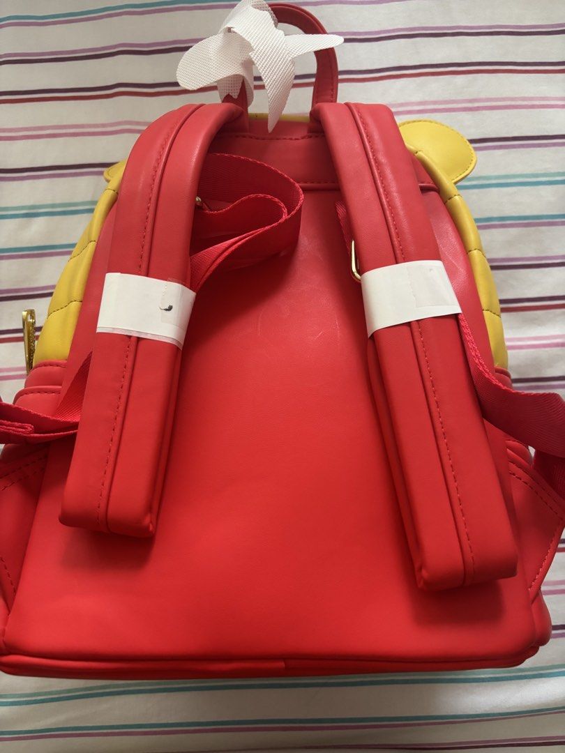 Disney Loungefly Winnie the Pooh Mini Backpack (Category: Backpacks) located in Muntinlupa City. Submitted by cameesan (Listing ID 1452738874, Image 2). Description: - Super cute Winnie the Pooh mini backpack by Loungefly. - Yellow quilted top featuring Pooh's face. - Red bottom with convenient side pockets. - Interior lining with a fun, all-over Pooh pattern. - Adjustable straps for comfortable wear. - Ideal for Disney enthusiasts and daily use.