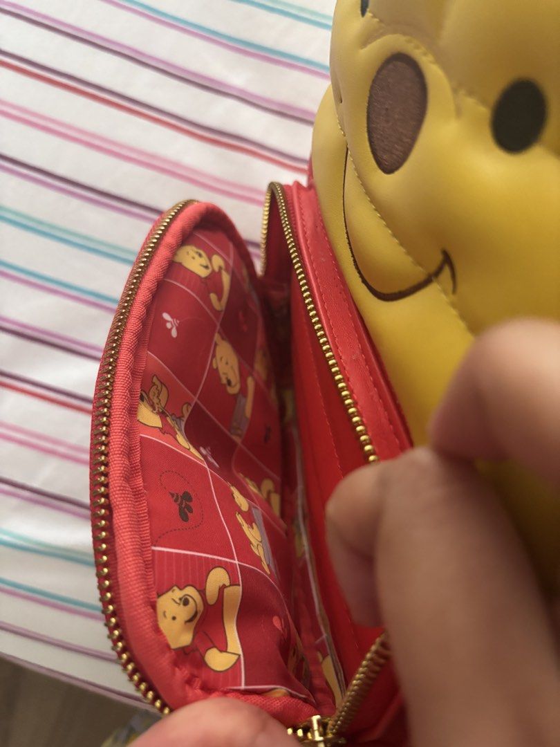 Disney Loungefly Winnie the Pooh Mini Backpack (Category: Backpacks) located in Muntinlupa City. Submitted by cameesan (Listing ID 1452738874, Image 3). Description: - Super cute Winnie the Pooh mini backpack by Loungefly. - Yellow quilted top featuring Pooh's face. - Red bottom with convenient side pockets. - Interior lining with a fun, all-over Pooh pattern. - Adjustable straps for comfortable wear. - Ideal for Disney enthusiasts and daily use.