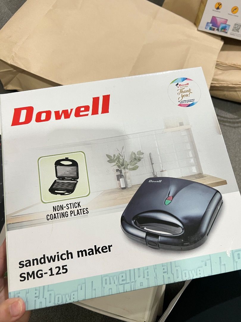 Dowell Sandwich Maker SMG-125 Non-Stick Coating Plates (Category: Cookware & Accessories) located in Caloocan City. Submitted by lilfinds (Listing ID 1452832719, Image 3). Description: - Dowell Sandwich Maker SMG-125 - Non-stick coating plates for easy cleaning - Compact design, perfect for small kitchens - Indicator lights (red & green) for easy operation - Ideal for making quick and delicious snacks and meals.