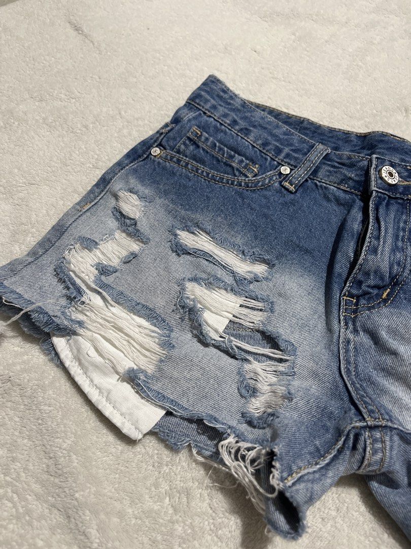 Fast Fish Ripped Denim Shorts Size 27 (Category: Shorts) located in Caloocan City. Submitted by unicakczxc (Listing ID 1452794767, Image 2). Description: - Blue denim 🩳 - Size 27 - Distressed rips and frayed hem - Ombre effect (blue to white) - Cute sun embroidery on back pocket - Button and zip closure USED BUT NOT ABUSED GOOD AS NEW DECLUTTERING.