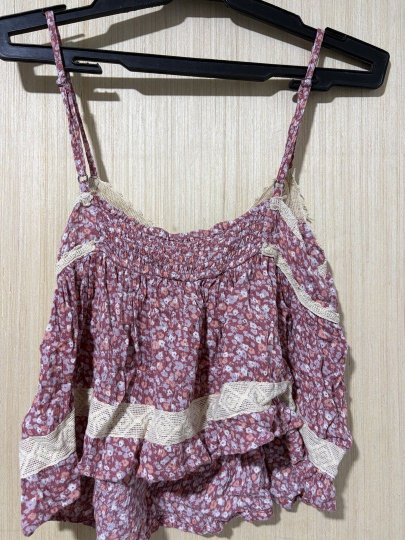 Floral Cami Top with Lace Trim (Category: Sleeveless) located in Pasay City. Submitted by a.daneee (Listing ID 1452835448, Image 2). Description: - Adorable floral print cami top - Smocked bust for a comfortable fit - Delicate lace trim details - Adjustable straps for a customizable fit - Flirty ruffled hemline - Versatile for layering or wearing on its own - Made from lightweight, breathable fabric.