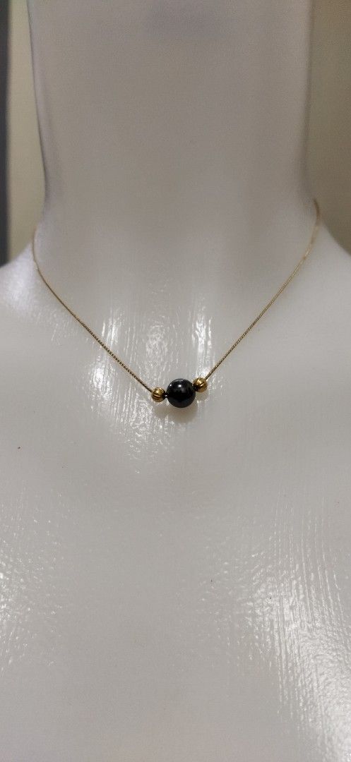 Gold Chain Necklace with Black stone and Gold Beads (Category: Necklaces) located in Santa Cruz. Submitted by madonnaching (Listing ID 1452726310, Image 1). Description: - Simple and dainty gold chain necklace - Features a single black stone in the center - Accented by two small gold beads on either side - Delicate and thin chain - Perfect for everyday wear or layering - Adds a subtle touch of elegance (this is from japan auction selling as fashi