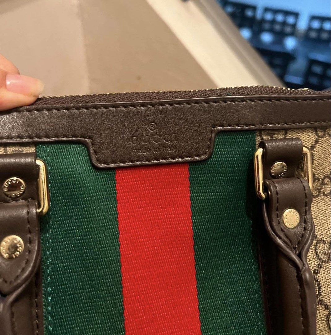 Gucci Monogram Canvas & Leather Stripe Boston Bag (Category: Luxury Bags & Wallets) located in Muntinlupa City. Submitted by mj.finds (Listing ID 1452808757, Image 1). Description: - Gucci Boston Bag - Classic GG monogram canvas - Signature green and red stripe detail - Interior zip pocket with minor marks - Serial number visible inside - Ideal for everyday use.