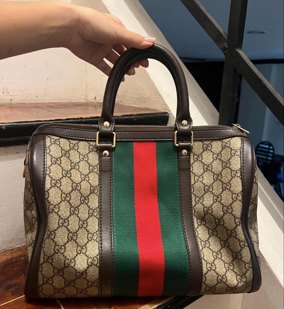 Gucci Monogram Canvas & Leather Stripe Boston Bag (Category: Luxury Bags & Wallets) located in Muntinlupa City. Submitted by mj.finds (Listing ID 1452808757, Image 2). Description: - Gucci Boston Bag - Classic GG monogram canvas - Signature green and red stripe detail - Interior zip pocket with minor marks - Serial number visible inside - Ideal for everyday use.