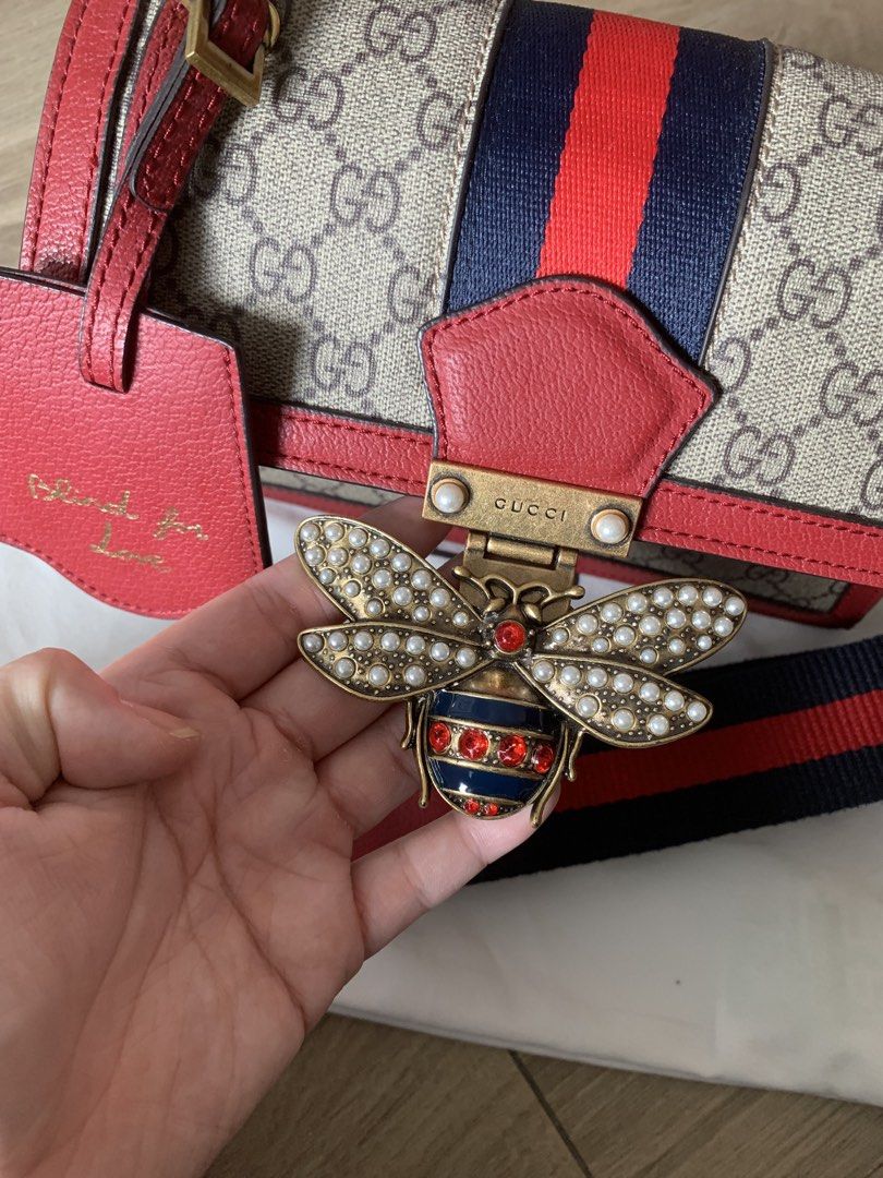 Gucci Queen Margaret Bag (Category: Luxury Bags & Wallets) located in Quezon City. Submitted by nikkigodmd (Listing ID 1452738301, Image 3). Description: - Iconic red and blue web stripe - Luxurious red leather trim - Cute 'Blind for Love' luggage tag - Spacious interior with multiple compartments - Secure interior zip pocket - Detachable strap for versatile styling - Elegant gold hardware details.