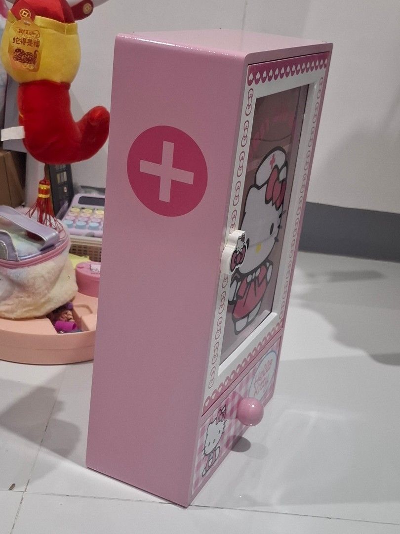 Hello Kitty First Aid Box Pink Storage Organizer (Category: Storage Boxes & Baskets) located in Batangas. Submitted by belleandbela (Listing ID 1452862993, Image 2). Description: - Adorable pink Kitty design - Features a clear window for easy visibility - Multiple compartments for organized storage - Ideal for first aid supplies, small items, or as a decorative piece - A must-have for any Kitty enthusiast's room.