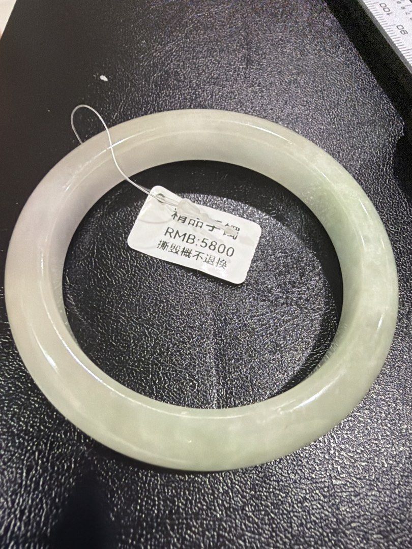 Jade bangle (Category: Bracelets) located in Singapore. Submitted by totetote123 (Listing ID 1452820534, Image 2). Description: Near translucent colour bangle… with tint of purple and light green dust bangle 548mm inner diameter .