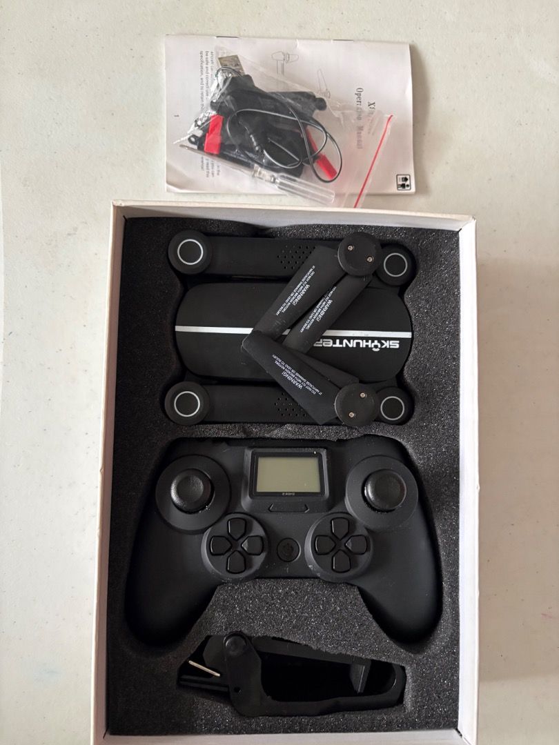 Jiestar Skyhunter (Category: Drones) located in Pasig City. Submitted by chingketeesph (Listing ID 1452711126, Image 1). Description: - Brand: Jiestar - Model: Skyhunter - Color: Black - Design: Sleek, foldable arms - Features: Includes drone controller (AAA battery not included), manual, mobile phone holder for flight monitoring, extra propellers, charging cable, drone battery pack and screwdriver - Condition: Good as new (tested 101% working) a