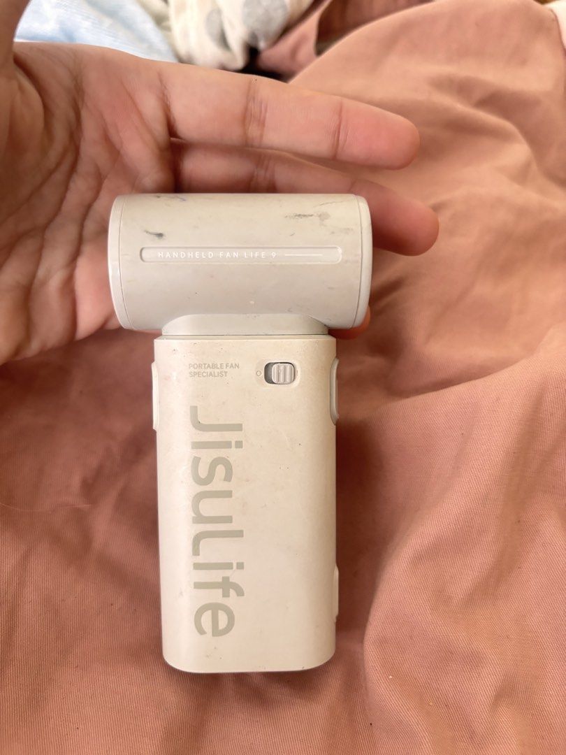 Jisulife Portable Handheld Fan Life 9 (Category: Fans) located in Manila. Submitted by kairs.preloved (Listing ID 1452700919, Image 3). Description: - Jisulife Portable Fan - Model Life 9 - Color: White - Features: Power button and adjustable speed dial - Power Source: Rechargeable battery - Benefits: Compact, easy to carry, perfect for personal cooling on the go - Condition: Minor scuffs from normal use.