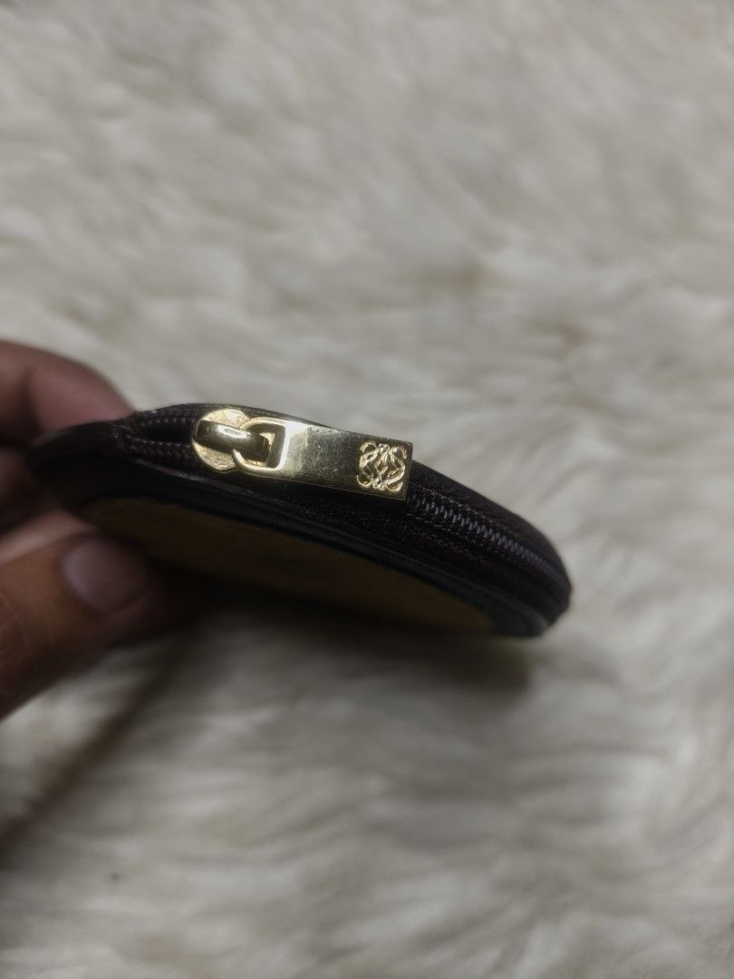 Loewe Leather Suede Coin Pouch (Category: Luxury Bags & Wallets) located in Alaminos. Submitted by thriftpill0302 (Listing ID 1452820826, Image 3). Description: - Authentic Loewe coin pouch - Made with premium leather and suede - Iconic Loewe anagram logo detail - Secure zipper closure with branded pull - Interior stamped 'LOEWE MADRID' - Compact and versatile for coins or small essentials.