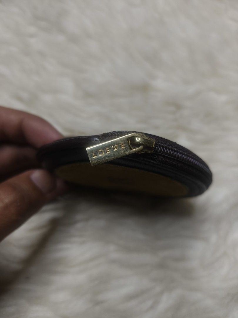 Loewe Leather Suede Coin Pouch (Category: Luxury Bags & Wallets) located in Alaminos. Submitted by thriftpill0302 (Listing ID 1452820826, Image 2). Description: - Authentic Loewe coin pouch - Made with premium leather and suede - Iconic Loewe anagram logo detail - Secure zipper closure with branded pull - Interior stamped 'LOEWE MADRID' - Compact and versatile for coins or small essentials.