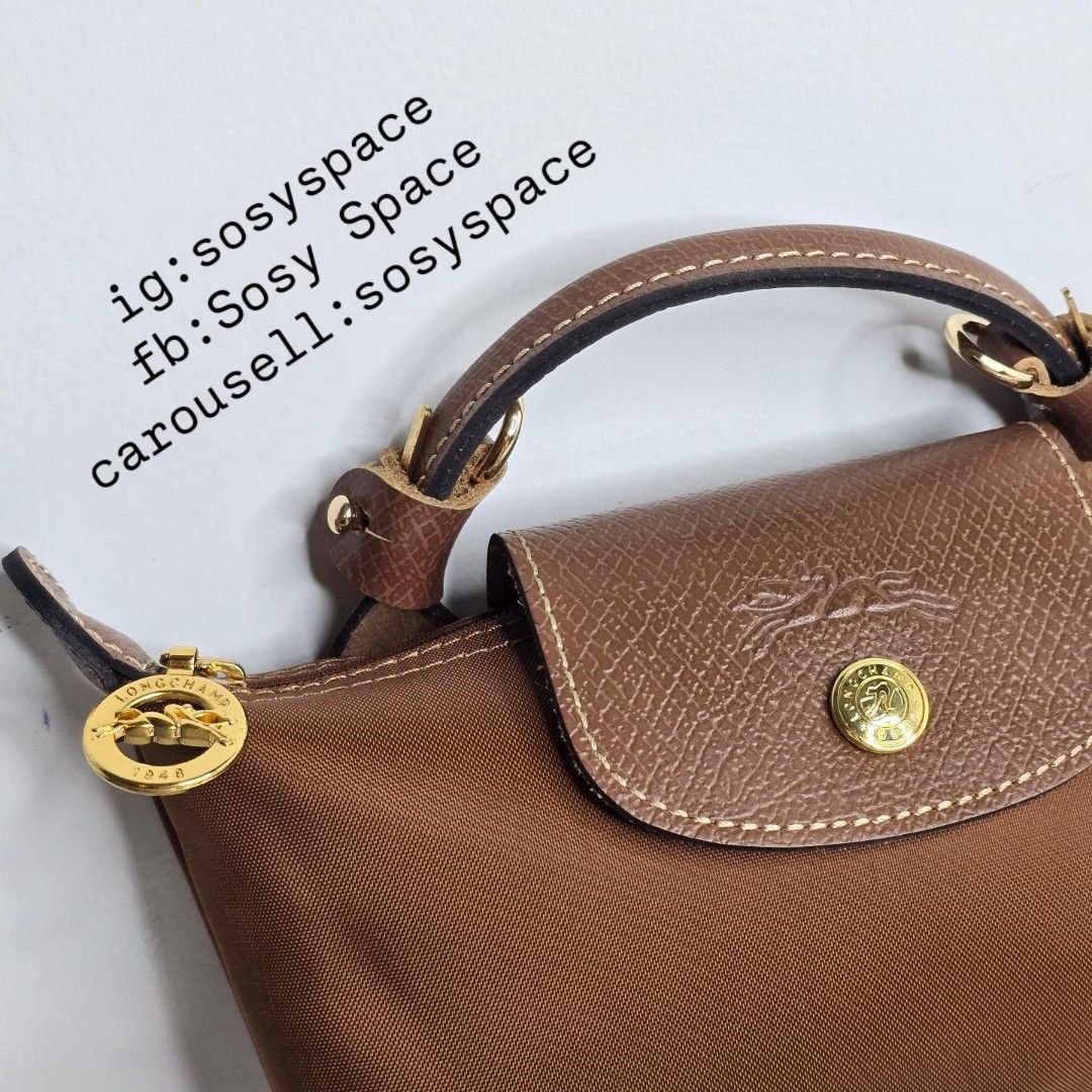 Longchamp Le Pliage Original Pouch With Handle And Sling Strap (Category: Luxury Bags & Wallets) located in Lucena. Submitted by sosyspace (Listing ID 1452734362, Image 2). Description: L. O. N. G. C. H. A. M. P. 02B2P77 Le Pliage Original Pouch w/ Handle and Sling Strap 34175089504 6.7 x 2.2 x 4.3 inches Recycled Polyamide Canvas W/ Inside Coating Russian Cowhide Leather Gold Hardware Snap Button and Zip Closure France Condition: Brand New Final