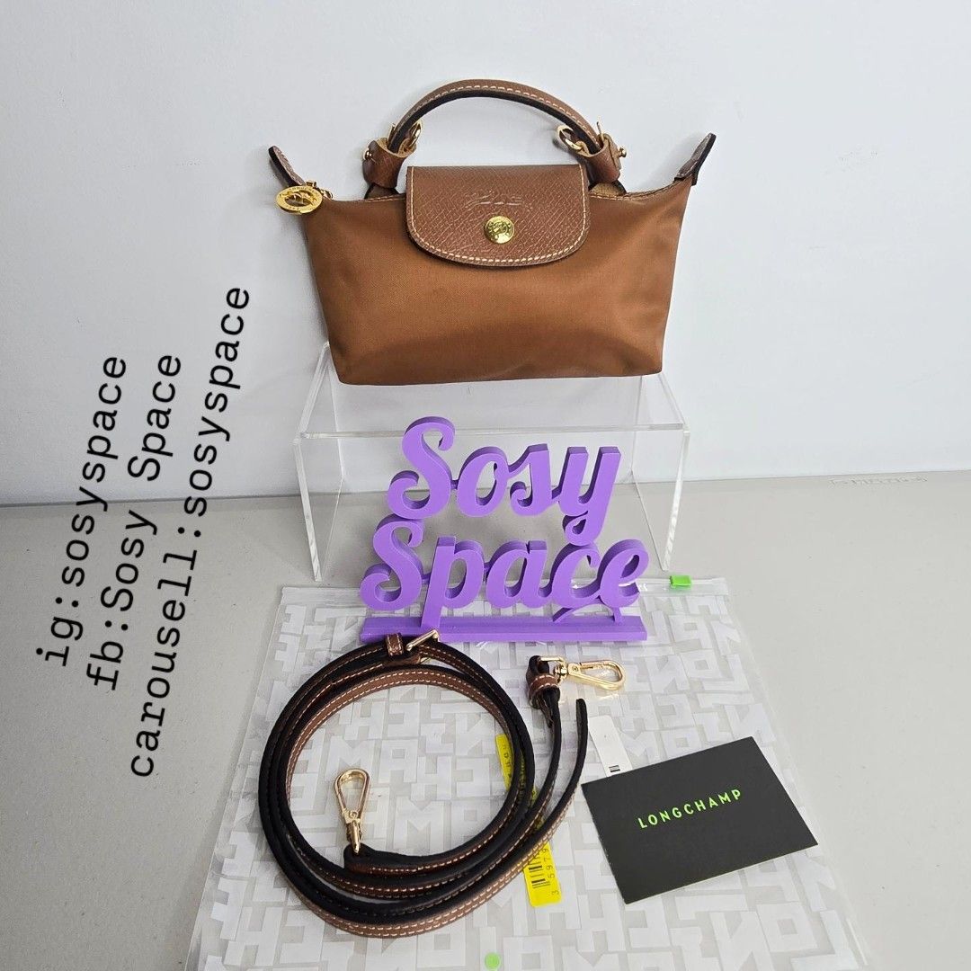 Longchamp Le Pliage Original Pouch With Handle And Sling Strap (Category: Luxury Bags & Wallets) located in Lucena. Submitted by sosyspace (Listing ID 1452734362, Image 1). Description: L. O. N. G. C. H. A. M. P. 02B2P77 Le Pliage Original Pouch w/ Handle and Sling Strap 34175089504 6.7 x 2.2 x 4.3 inches Recycled Polyamide Canvas W/ Inside Coating Russian Cowhide Leather Gold Hardware Snap Button and Zip Closure France Condition: Brand New Final