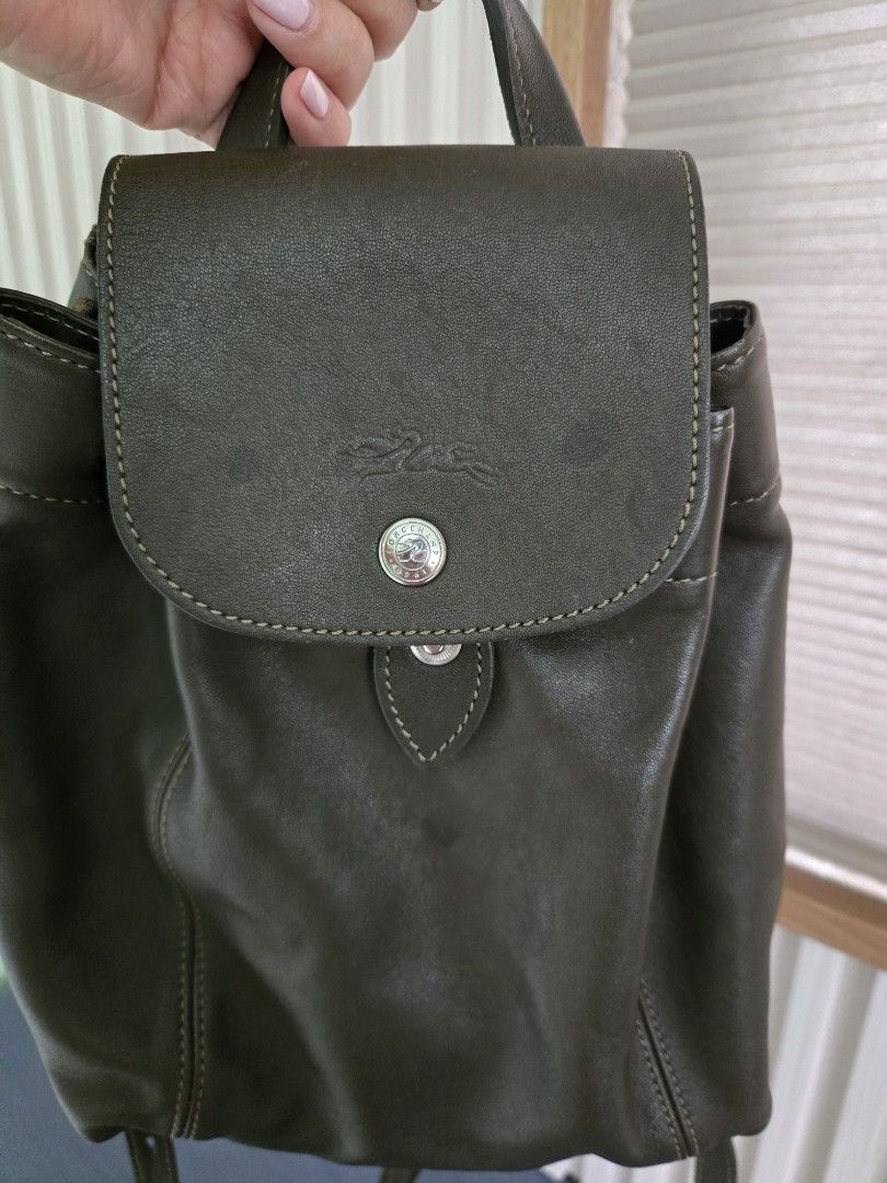 Longchamp Leather Backpack and Shoulder Bag (Category: Backpacks) located in Cebu City. Submitted by mcsang (Listing ID 1452829235, Image 2). Description: - Dark green leather backpack with drawstring and flap closure - Interior zippered pocket in backpack - Light blue leather shoulder bag with flap closure - Both bags feature the Longchamp logo - Ideal for everyday use or travel.