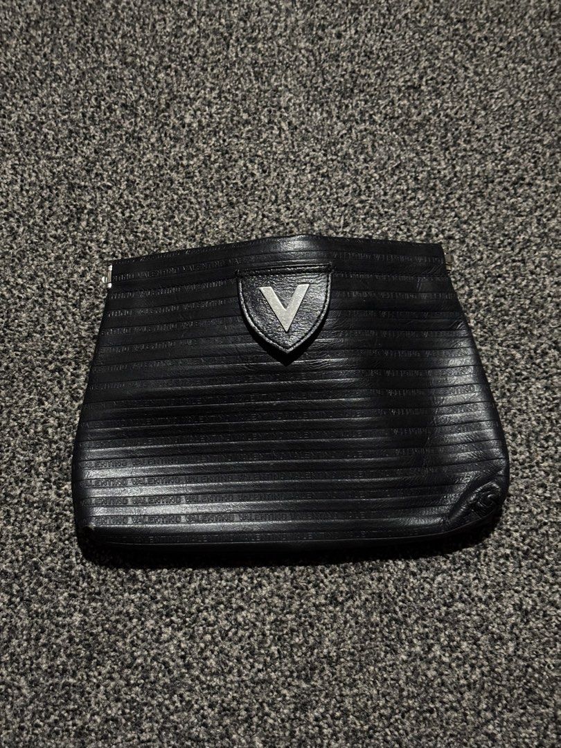 Mario Valentino Clutch Bag Embossed Logo (Category: Clutches) located in Bulacan. Submitted by thriftstarph (Listing ID 1452790709, Image 1). Description: PLEASE READ THE DESCRIPTION BELOW‼️ Mario Valentino Clutch Bag Embossed Logo Iconic V Logo From: Japan No Box Issue: Minor Flaws NEGOTIABLE .