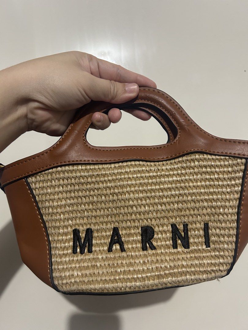 MARNI Straw and Leather Mini Tote Bag (Category: Luxury Bags & Wallets) located in Makati City. Submitted by michellecollado07 (Listing ID 1452803318, Image 2). Description: NOT AUTHENTIC - Cute MARNI mini tote bag - Woven straw body - Brown leather trim and handles - MARNI logo embroidered on front - Branded tag inside - Small and stylish, ideal for essentials - Perfect for casual day outs.