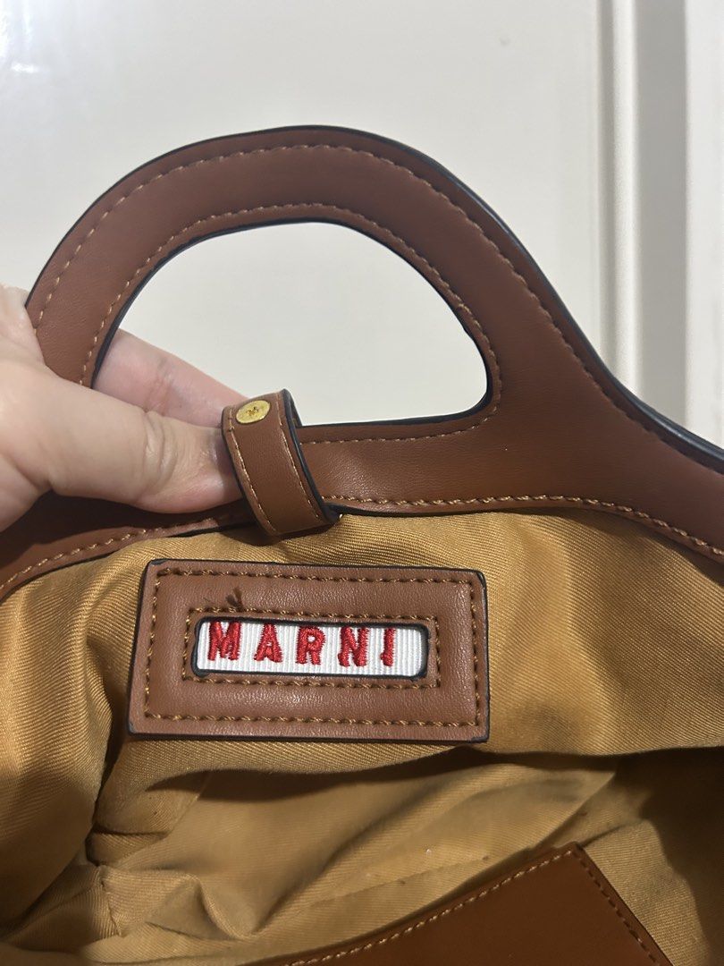 MARNI Straw and Leather Mini Tote Bag (Category: Luxury Bags & Wallets) located in Makati City. Submitted by michellecollado07 (Listing ID 1452803318, Image 3). Description: NOT AUTHENTIC - Cute MARNI mini tote bag - Woven straw body - Brown leather trim and handles - MARNI logo embroidered on front - Branded tag inside - Small and stylish, ideal for essentials - Perfect for casual day outs.