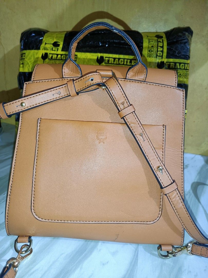MCM Essential Visetos Small Backpack (Category: Luxury Bags & Wallets) located in Bolinao. Submitted by shayne_0215 (Listing ID 1452755020, Image 3). Description: - Authentic MCM - Tan leather backpack with iconic MCM monogram print. - Comfortable top handle and adjustable shoulder straps. - Secure front flap closure with stylish buckle detail. - Convenient back pocket for quick access. - Ideal for everyday adventures and stylish commutes - Made 