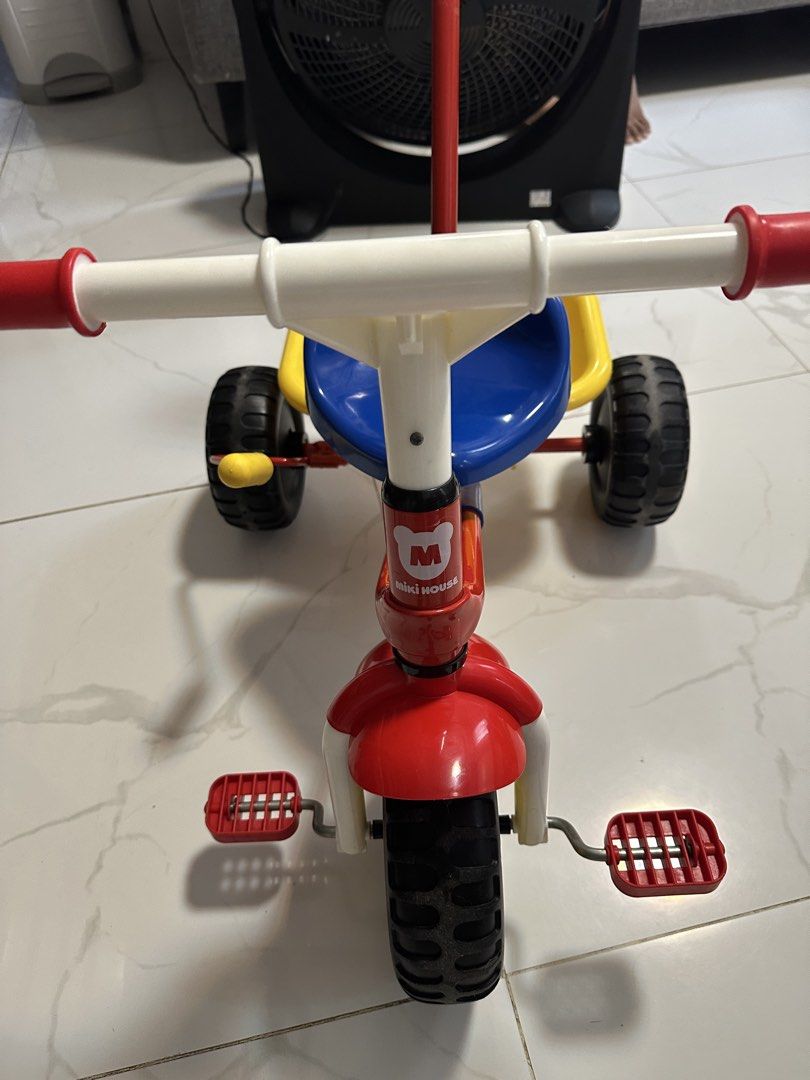 Miki House Tricycle with Parent Handle (Category: Babies & Kids Fashion) located in Trece Martires City. Submitted by soriaalma57578 (Listing ID 1452746622, Image 2). Description: - Red and yellow Miki House tricycle - Includes parent push handle for guidance - Comfortable blue seat - Convenient yellow storage bin - Red handlebars with white grips - Pedals attached to the front wheel - Ideal for children learning to ride - Fun and sturdy design f