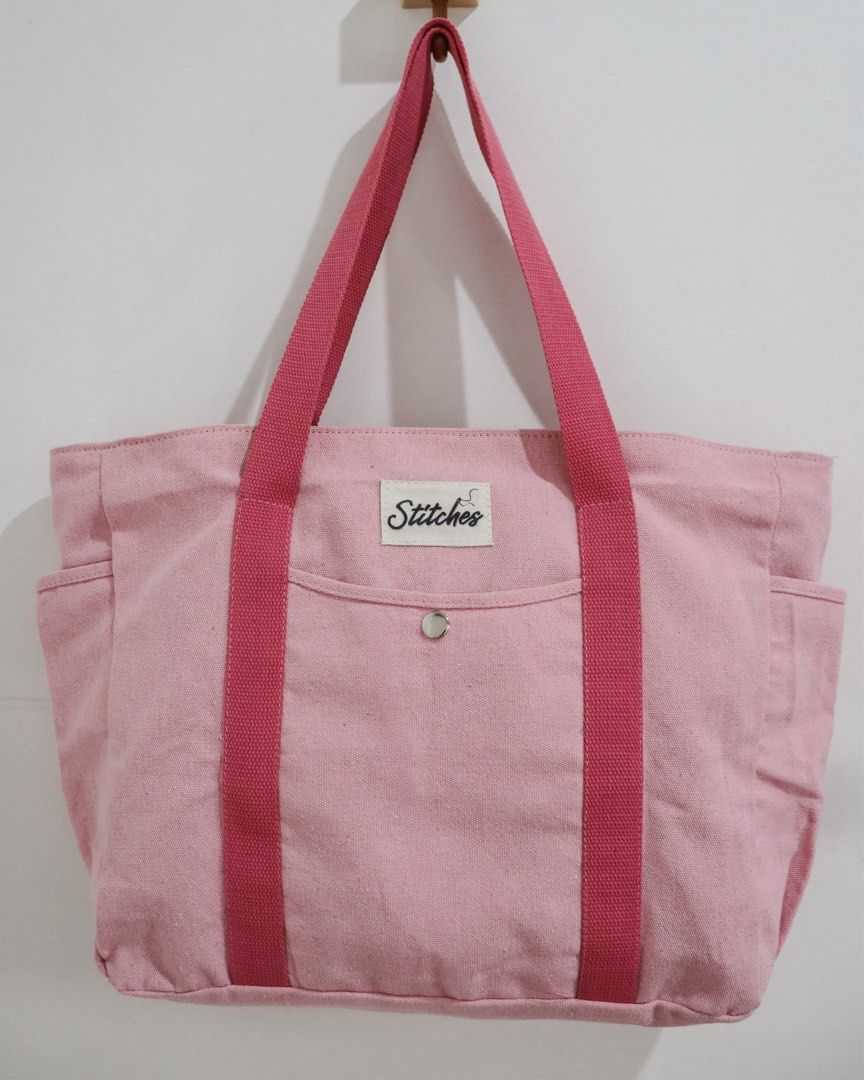 Multi-Pocket Heavy Duty Canvas Tote Bag (Category: Tote Bags) located in Marikina City. Submitted by hellolei_c (Listing ID 1452814221, Image 1). Description: Material: Heavy-duty, thick canvas fabric for long-lasting durability. Main Closure: Top zip closure to keep your items safe and secure. Exterior Pockets: **Front quick-access slip pocket with a secure metal snap button closure **2 Deep side pockets (ideal for water bottles, umbrellas, or p