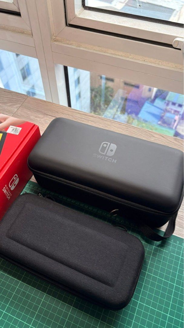 Nintendo Switch OLED Model White with Accessories (Category: Nintendo) located in Quezon City. Submitted by EMSLORENZO (Listing ID 1452764545, Image 2). Description: - Nintendo Switch OLED Model (White) - Includes original dock and Joy-Cons - All necessary charging cables included - Comes with Nacon protective travel case XL - Extra Joy-Con grips for enhanced comfort - Pre-applied screen protector for immediate use - Original packaging included -