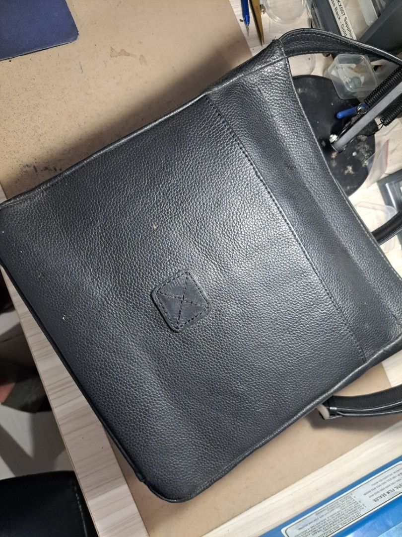OUR TRIBE Black Leather Crossbody Bag (Category: Sling Bags) located in Makati City. Submitted by arjay1026 (Listing ID 1452739932, Image 3). Description: Our Tribe Genuien Leather Sling Bag Medium Size 100% orig leather 9/10 condition suoer tibay - Classic black leather crossbody bag - Main zipper compartment - External zipper pocket on the front - Adjustable strap - Simple and timeless design - Ideal for everyday use.
