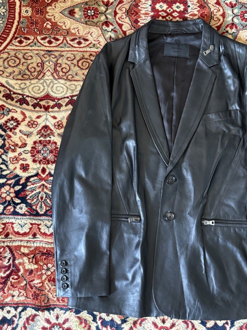 Prada - Tactical - Lambskin Leather Blazer (Category: Luxury Apparel) located in San Fernando. Submitted by larchivefeminine (Listing ID 1452716814, Image 2). Description: Prada - Tactical - Lambskin Leather Blazer Collared Zipper / Pockets Fresh Leather Size on tag : 52 Dimensions Width : 21.5in Length : 27in Sleeve : 25in Shoulder : 18in Condition : 9/10 No major flaws Soft Leather Made in : China Material : Lambskin Zipper : Opti Color : Black