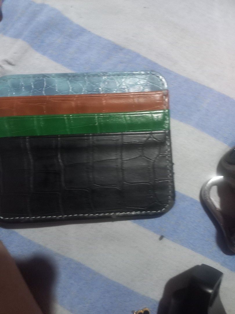 Prada Cardholder Black Crocodile Pattern Multi-Color Stripes (Category: Luxury Bags & Wallets) located in Taguig. Submitted by blessedlupie (Listing ID 1452736804, Image 2). Description: - Authentic Prada cardholder - Color: Black with crocodile texture - Design: Three colorful stripes on the side (light blue, orange, green) - Accent: Small Prada triangle logo on the front - Functionality: Ideal for holding cards flaws rubs on edges some area.