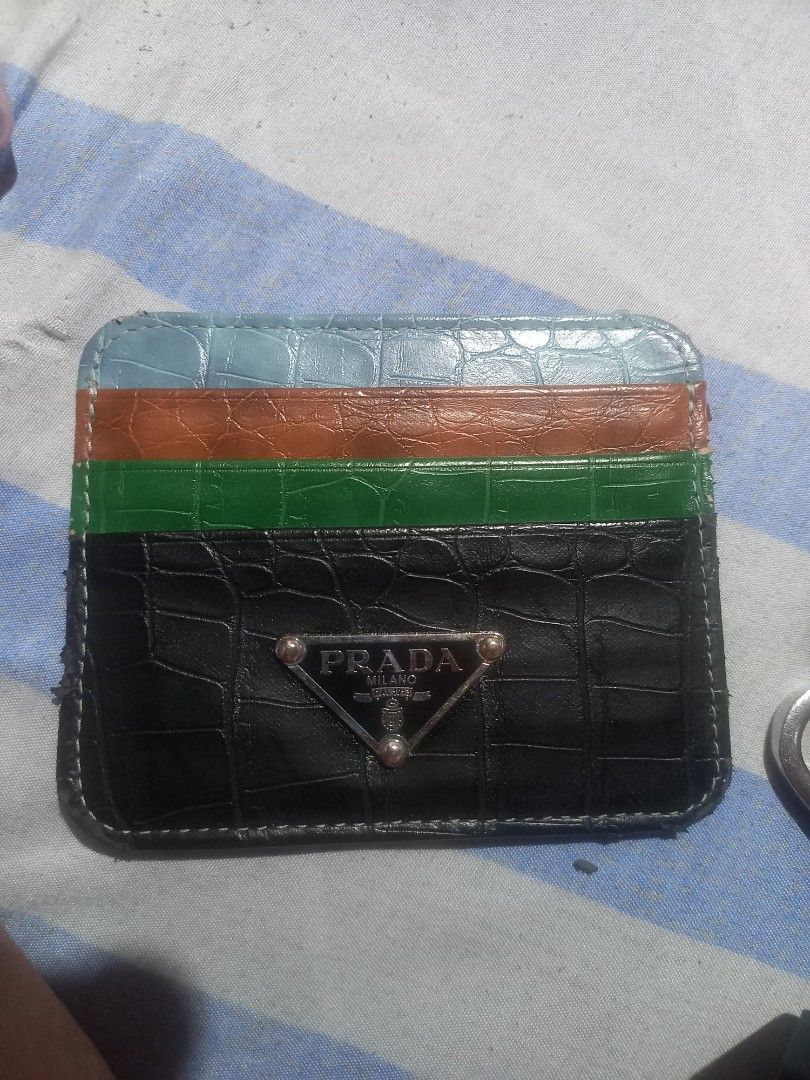 Prada Cardholder Black Crocodile Pattern Multi-Color Stripes (Category: Luxury Bags & Wallets) located in Taguig. Submitted by blessedlupie (Listing ID 1452736804, Image 1). Description: - Authentic Prada cardholder - Color: Black with crocodile texture - Design: Three colorful stripes on the side (light blue, orange, green) - Accent: Small Prada triangle logo on the front - Functionality: Ideal for holding cards flaws rubs on edges some area.
