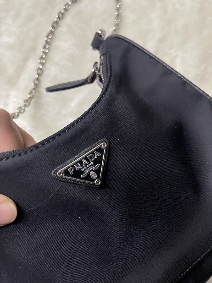 Prada Nylon Shoulder Bag Silver Chain (Category: Luxury Bags & Wallets) located in Baguio. Submitted by randomly2600 (Listing ID 1452812954, Image 2). Description: - Classic black Prada shoulder bag - Durable nylon material - Silver-tone chain strap - Iconic Prada triangle logo on front - Zipper closure - Versatile for everyday use or nights out.