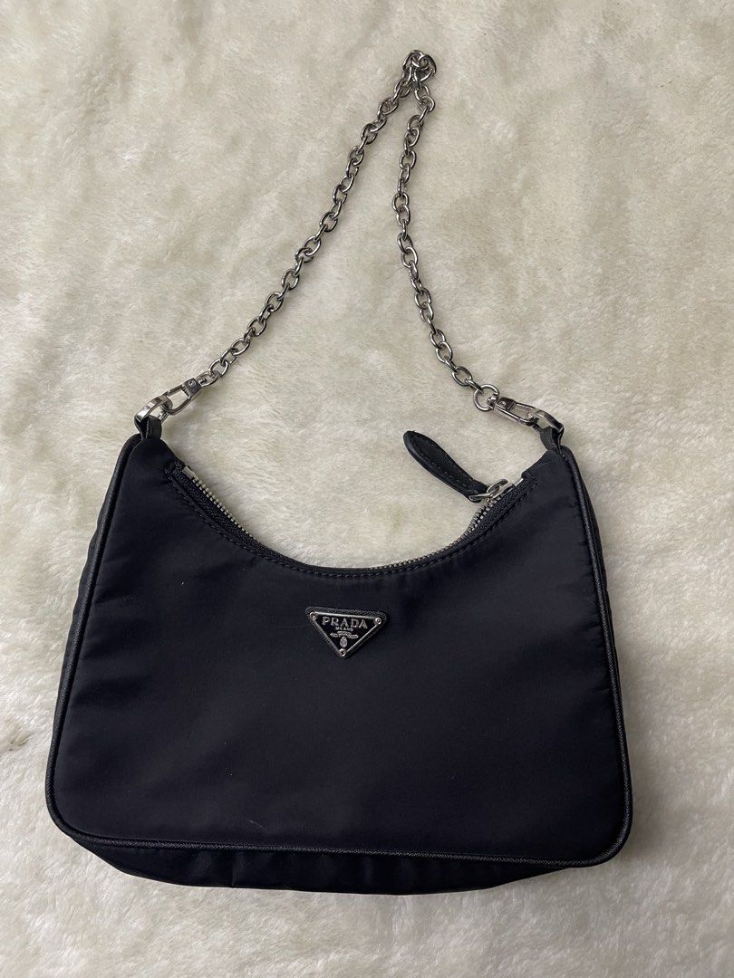 Prada Nylon Shoulder Bag Silver Chain (Category: Luxury Bags & Wallets) located in Baguio. Submitted by randomly2600 (Listing ID 1452812954, Image 1). Description: - Classic black Prada shoulder bag - Durable nylon material - Silver-tone chain strap - Iconic Prada triangle logo on front - Zipper closure - Versatile for everyday use or nights out.