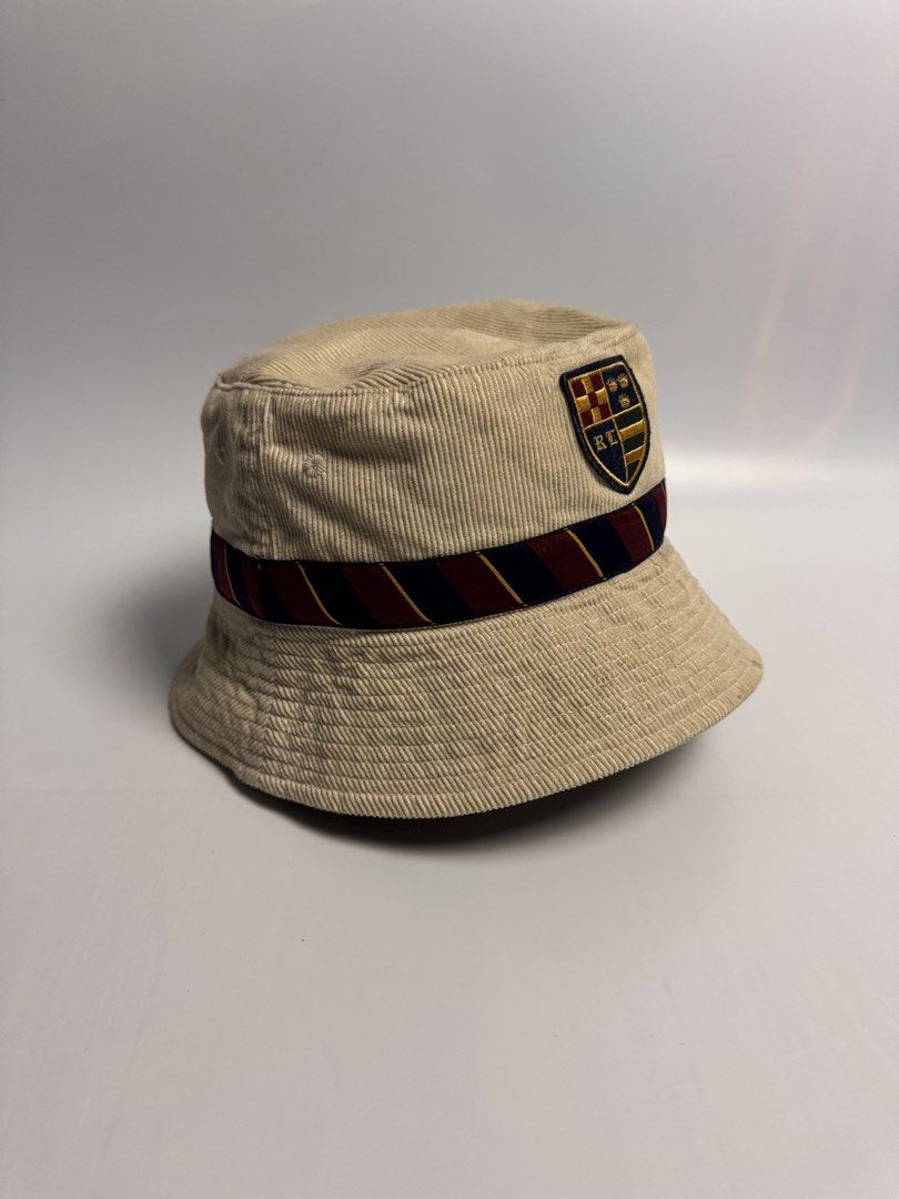 Ralph Lauren corduroy bucket hat (Category: Hats & Beanies) located in San Narciso. Submitted by gotgood.garments (Listing ID 1452862531, Image 2). Description: Cream corduroy bucket hat with a crest patch, stripe band (navy, maroon, yellow), and embroidered logo. Perfect for sunny days! Size: 6 7/8 (54cm).