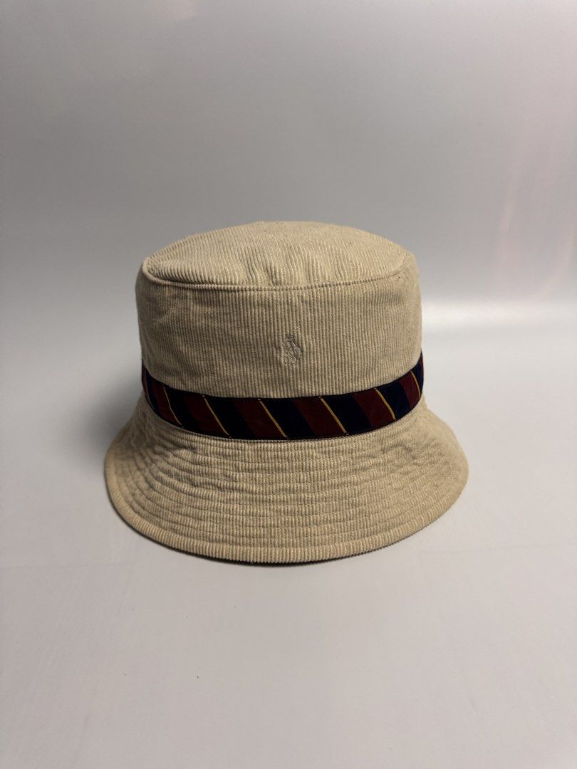 Ralph Lauren corduroy bucket hat (Category: Hats & Beanies) located in San Narciso. Submitted by gotgood.garments (Listing ID 1452862531, Image 3). Description: Cream corduroy bucket hat with a crest patch, stripe band (navy, maroon, yellow), and embroidered logo. Perfect for sunny days! Size: 6 7/8 (54cm).