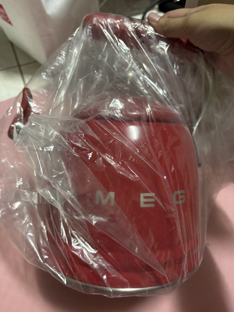 Red SMEG Kettle (Category: Kettles & Airpots) located in San Juan City. Submitted by claricecaswell22 (Listing ID 1452820524, Image 2). Description: - Red SMEG kettle - Brand new, still in original plastic packaging - Minor paint chips on the side (visible in the last photo) - A stylish addition to any kitchen.