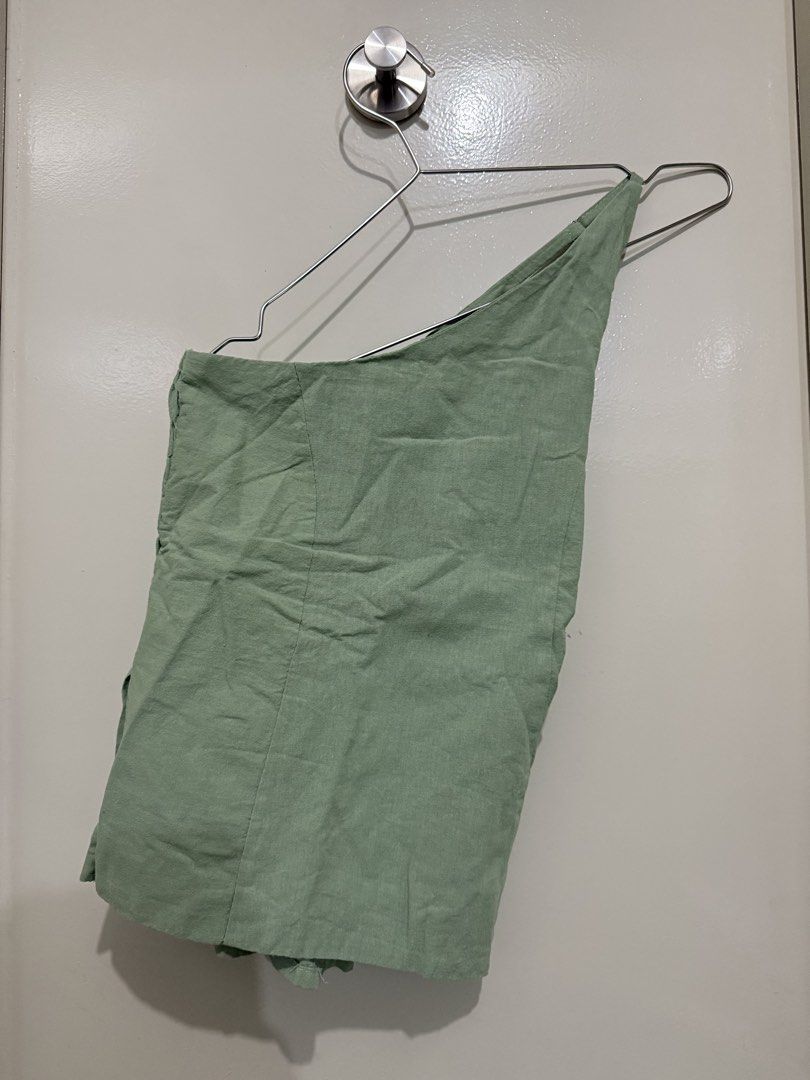 Sage Green One Shoulder Smocked Crop Top (Category: Sleeveless) located in Pasig City. Submitted by rchsh (Listing ID 1452825075, Image 1). Description: - Sage green one-shoulder top - Smocked bodice for a comfortable fit - Ruffled hem for a feminine touch - Lightweight fabric, ideal for summer weather - Versatile: pairs easily with shorts or skirts - Effortlessly cute and breezy style Never been used.