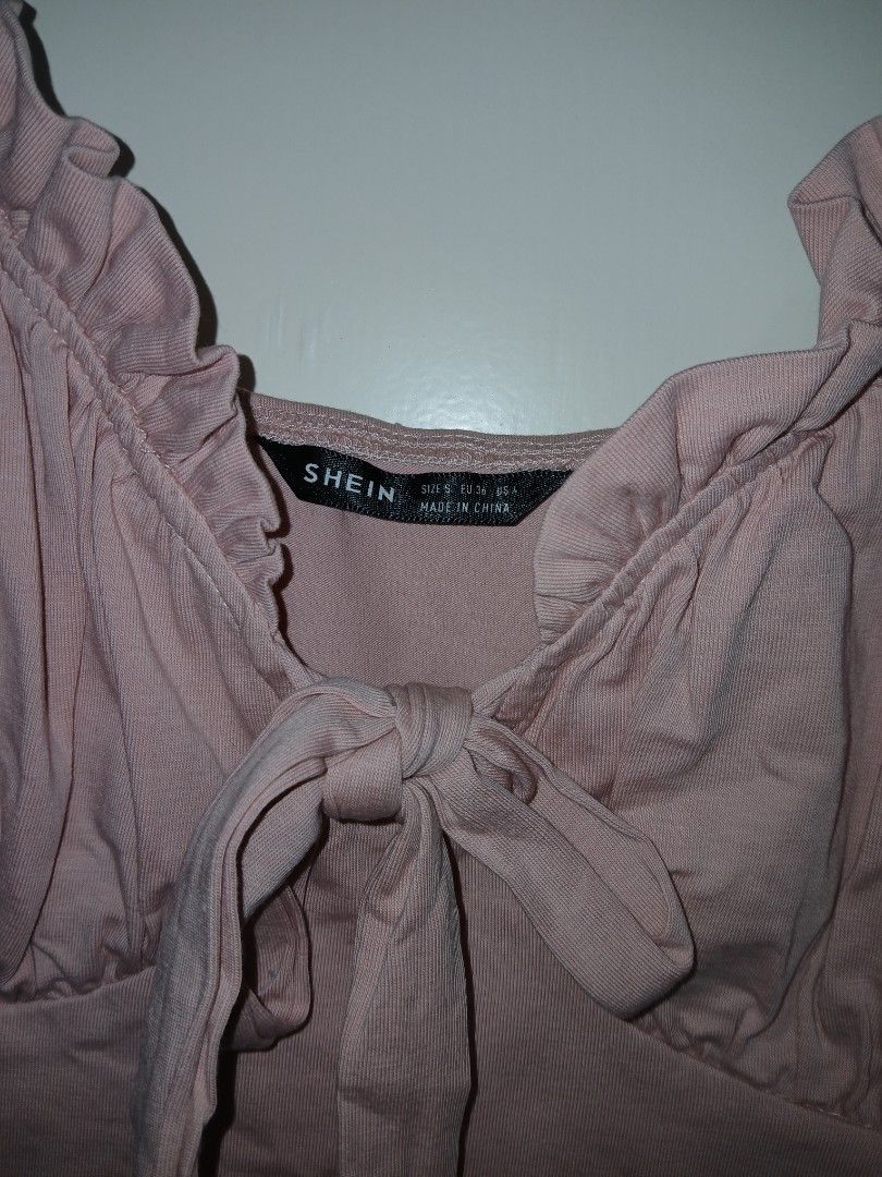 SHEIN Pink Bustier Ruched Tie Front Bodysuit (Category: Others Tops) located in Paranaque City. Submitted by thepennydreadful (Listing ID 1452745954, Image 2). Description: stretch. never worn. just stored - Pink ribbed bodysuit from SHEIN - Ruched detail on bust with tie front - Adjustable spaghetti straps - Super cute and comfy - Great for layering or wearing on its own.