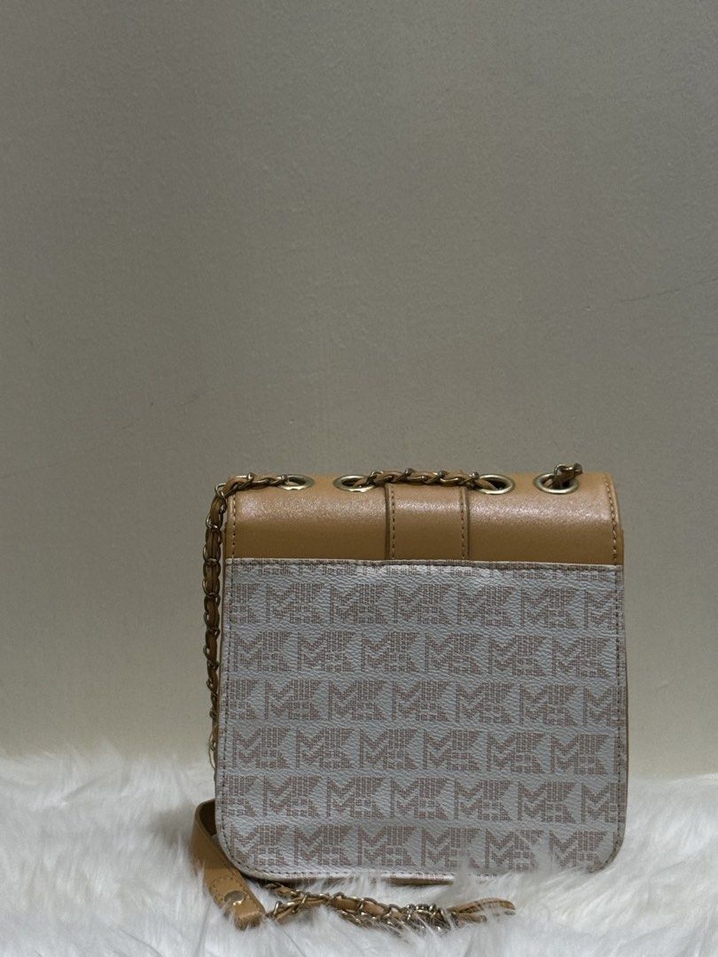 Tan & Monogram Canvas Flap Chain Crossbody Sling Bag (Category: Cross-body Bags) located in Quezon City. Submitted by clazzystudio (Listing ID 1452808932, Image 3). Description: Selling this chic tan crossbody bag featuring a classic monogram printed canvas body, smooth tan faux leather flap, and a circular gold-tone MK logo emblem. It features a sleek vertical envelope design and a long gold chain strap woven with leather. Perfect for adding an 