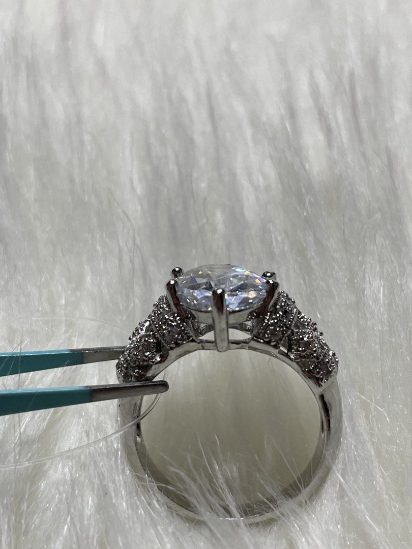 Sparkling Silver tone Ring with Large Clear Stone size 7-8 (Category: Rings) located in San Juan City. Submitted by redrosierose (Listing ID 1452832902, Image 3). Description: - Silver-toned statement ring size 8-9 Preloved Fashion Ring (Not Real Diamond) - Features a large, clear faceted stone - Intricate band detailing with smaller stones - Shiny and eye-catching design - Perfect for dressing up any outfit / parties -NOT REAL SILVER Shipping Ca